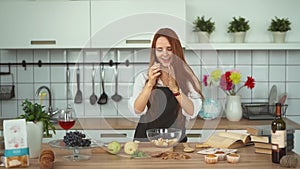 Smiling Ginger Woman Cooking Fresh Meal in Kitchen. Crazy red head girl.