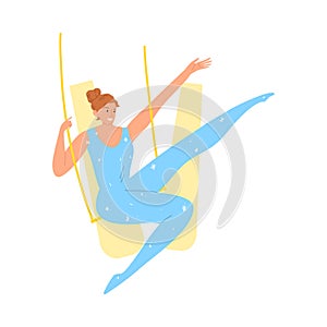 Smiling girl aerialist in blue costume during performance in circus