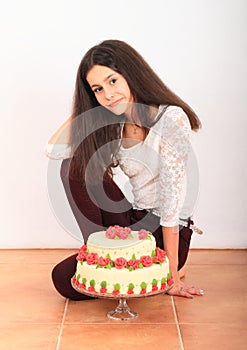 Smiling girl with anniversary cake