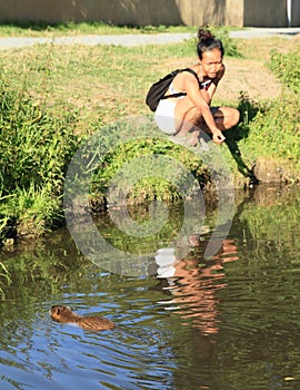 Smiling girl attracting nutria