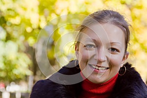 Smiling girl in autumn park