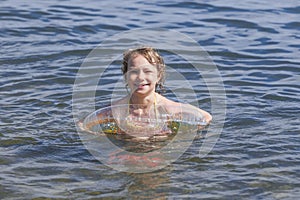 Smiling girl bathes in river