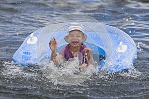 Smiling girl bathes in river