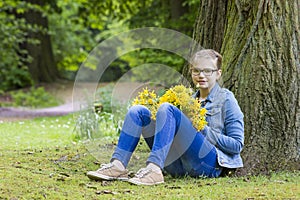 Smiling girl with big bouquet of spring flowers