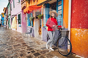 Smiling girl with a bike in Italy