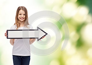 Smiling girl with blank arrow pointing right