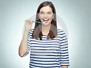 Smiling girl with brace brushing teeth