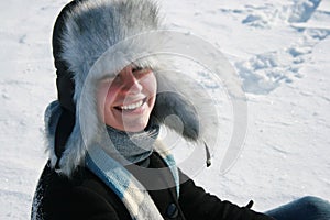 Smiling girl in cap with ear-flaps