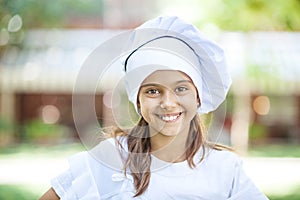 Smiling girl in a chef's hat