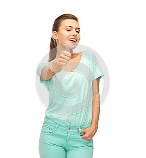 Smiling girl in color t-shirt showing thumbs up
