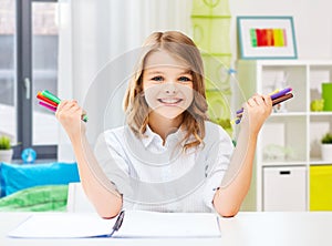 smiling girl with colorful felt-tip pens at home photo