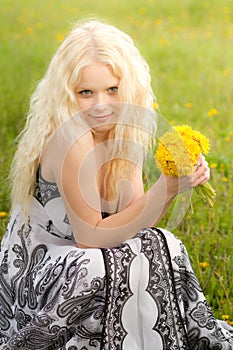 Smiling girl with dandelions, head