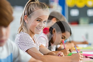 Smiling girl doing classwork