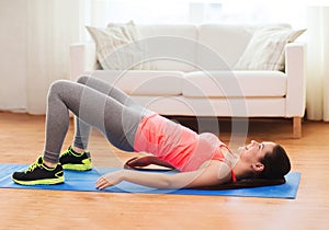 Smiling girl doing exercise for legs and buttocks