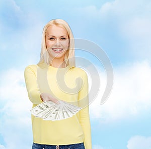 Smiling girl with dollar cash money