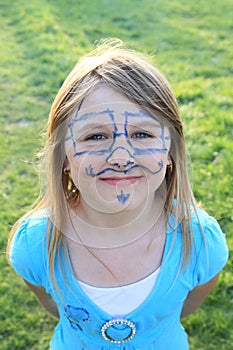 Smiling girl with drawings on face