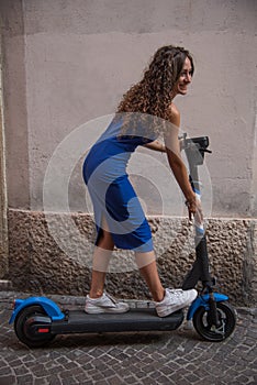 Smiling girl on electric scooter.