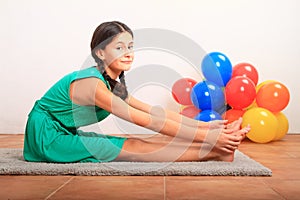 Smiling girl exercising yoga - seated forward fold