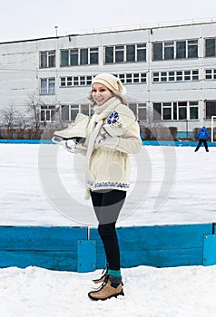 Smiling girl with fads on ice skating rink