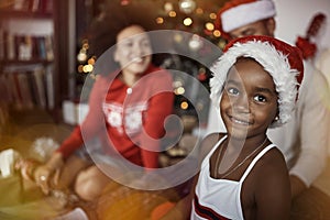 Smiling  girl in front of decorated Christmas tree.family celebrating Christmas together