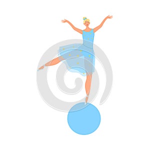 Smiling girl gymnast in blue costume making show on ball in circus photo