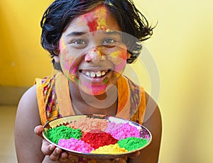 Smiling girl with happy mode celebrating Holi