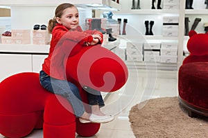 Smiling girl having fun in a big red toy