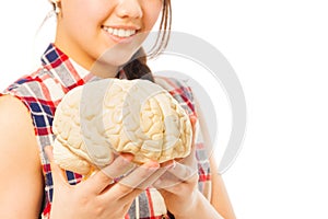 Smiling girl holding cerebrum model in her hands