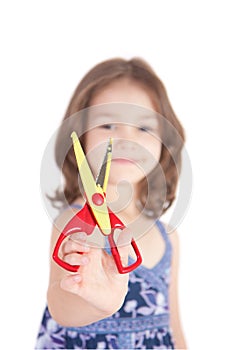 Smiling girl holding fun craft scissors