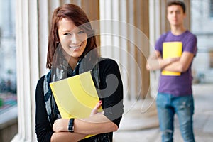 Smiling girl holding a notebook