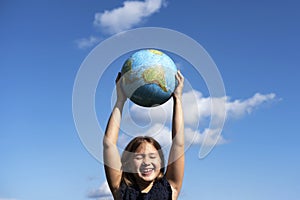 Smiling girl holding planet Earth