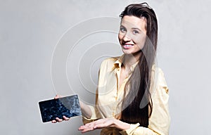 Smiling girl holding smarthpone with dirty touch screen.