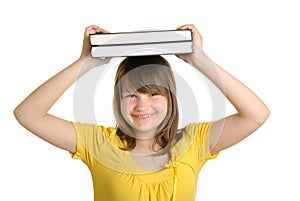 Smiling girl holds books on head