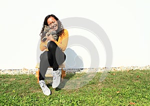 Smiling girl hugging a cat