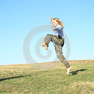 Smiling girl jumping on meadow