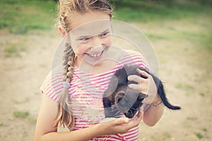 Smiling girl with kitten