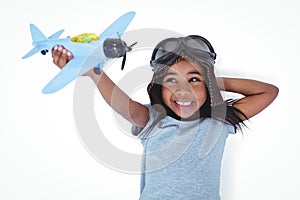 Smiling girl laying on the floor playing with toy airplane