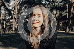 Smiling girl looking at camera in park outdoor