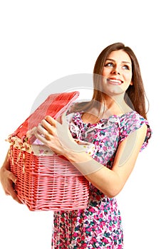 Smiling girl looking in a laundry basket on white background