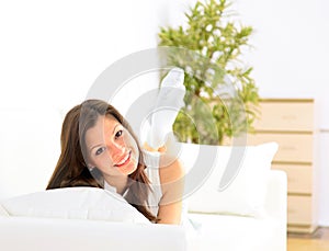 Smiling girl lying down on divan