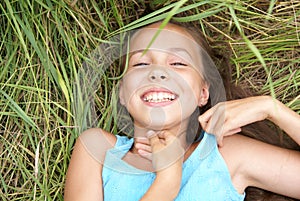 Smiling girl lying on grass