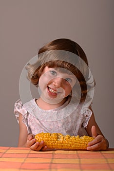 A smiling girl with maize