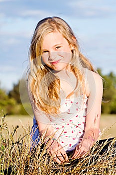 Smiling girl in meadow