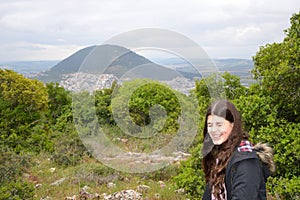A smiling girl with Mount Tabor as background