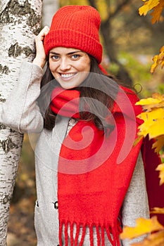 Smiling girl in the park. Autumn season.