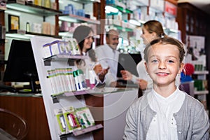 Smiling girl in a pharmacy