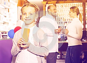 Smiling girl in a pharmacy