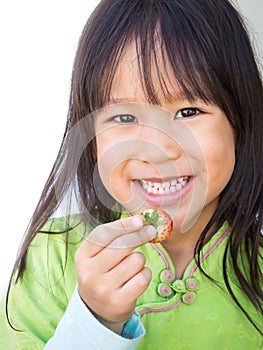 Smiling girl picking strawberry. Happy face. Portrait on white b