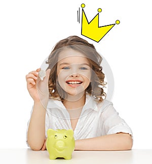 Smiling girl with piggy bank and euro coin