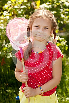 Smiling girl with a pink butterfly net